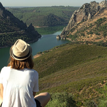 Young man looking out over the River Tagus on its course through the Monfragüe National Park.